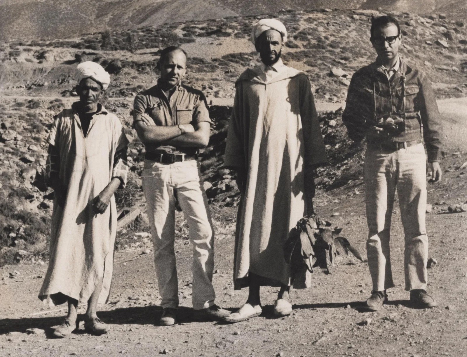 Fieldwork in the Atlas: four men on a rocky slope