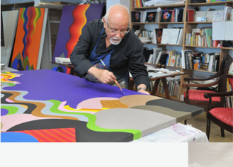 Melehi painting a canvas laid flat